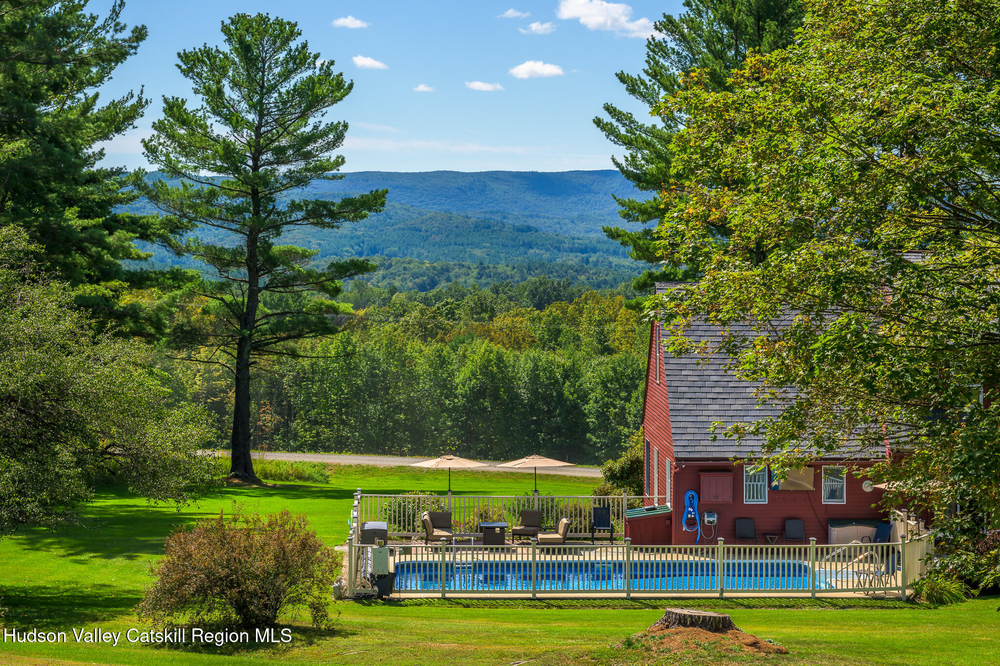 21 Stone House Road Canaan, NY 12029 - Photo 2 of 76 a view of an swimming pool with lawn chairs under an umbrella