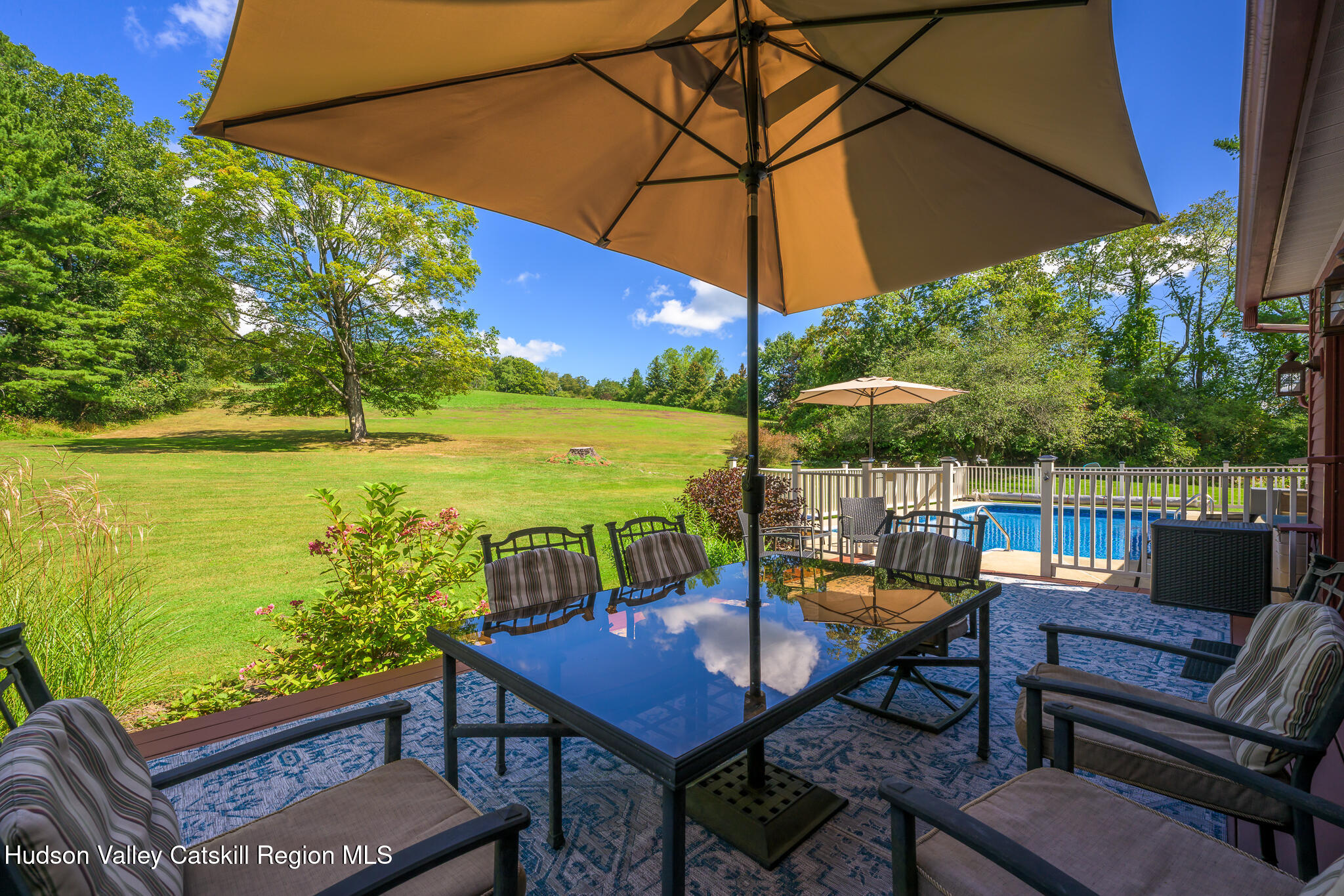 21 Stone House Road Canaan, NY 12029 - Photo 62 of 76 a view of a outdoor sitting area with furniture and umbrella