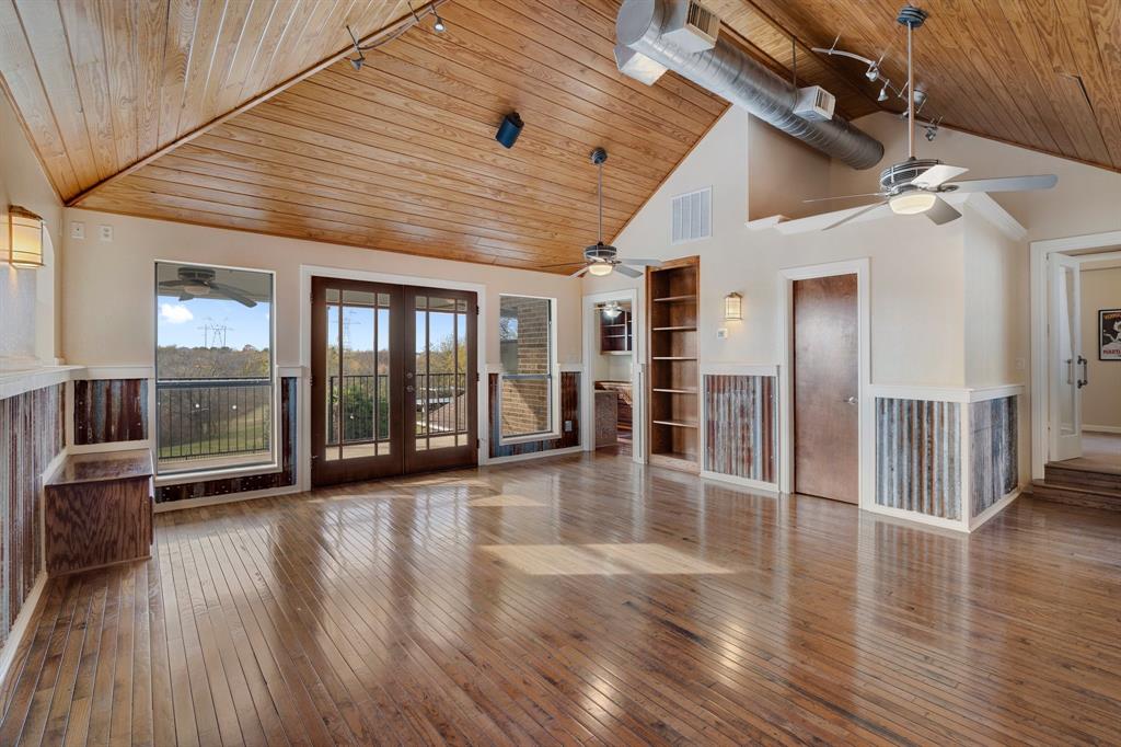 4421 Merritt Road Sachse, TX 75048 - Photo 24 of 38 an empty room with wooden floor and windows