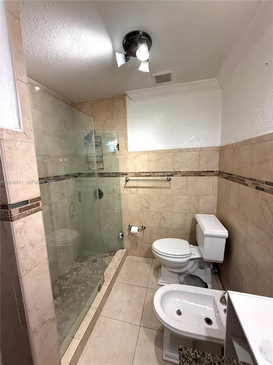 14770 Southwest 60th Street Miami, FL 33193 - Photo 11 of 16 a bathroom with a toilet a sink and a shower