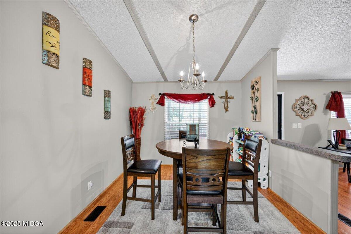 1659 Henderson Road Macon, GA 31217 - Photo 13 of 44 a view of a dining room with furniture and a chandelier