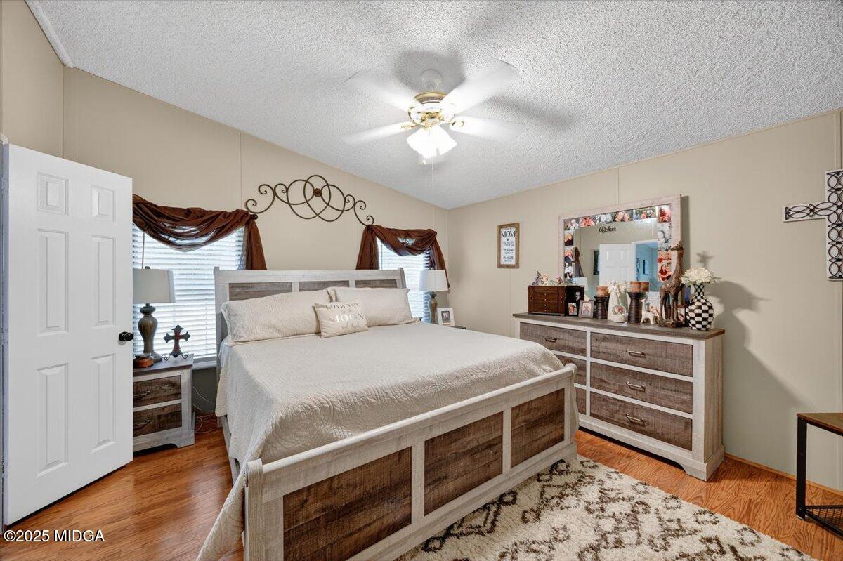 1659 Henderson Road Macon, GA 31217 - Photo 15 of 44 a bedroom with a bed and a chandelier