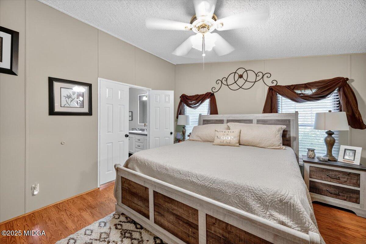 1659 Henderson Road Macon, GA 31217 - Photo 16 of 44 a bedroom with a bed and a chandelier