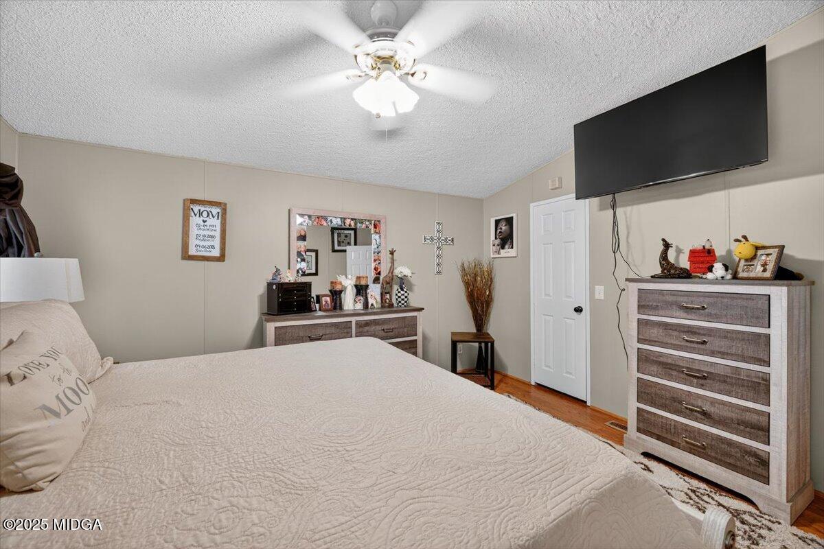 1659 Henderson Road Macon, GA 31217 - Photo 17 of 44 a bedroom with a bed and a flat screen tv
