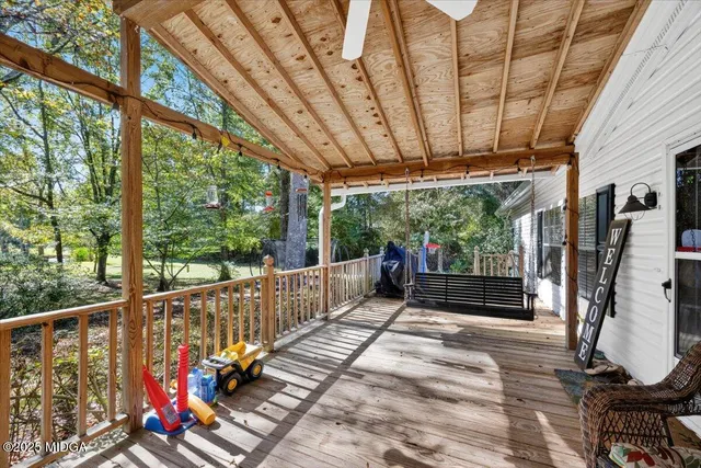 a view of a balcony with couch swing