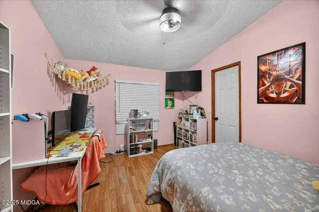 a bed room with a bed and a tv