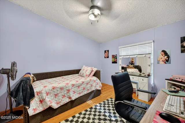 a bedroom with bed and a chandelier