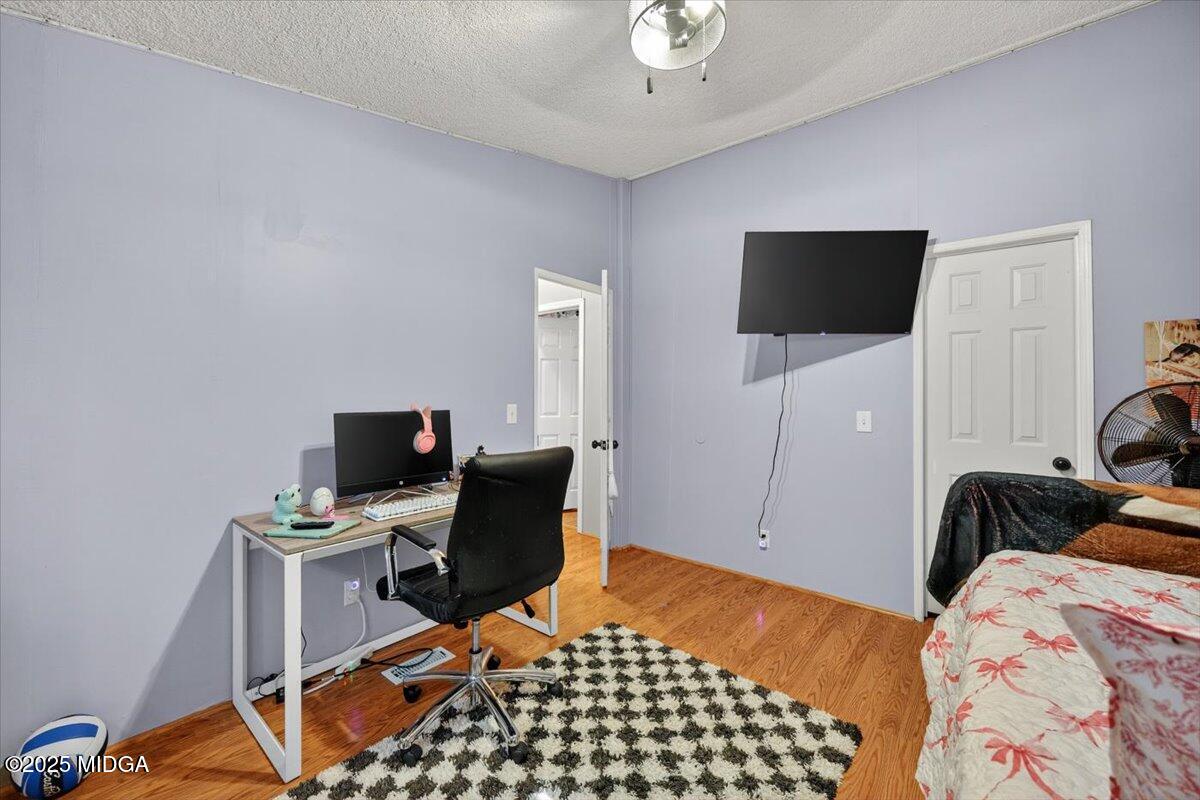 1659 Henderson Road Macon, GA 31217 - Photo 25 of 44 a bedroom with a bed and flat screen tv