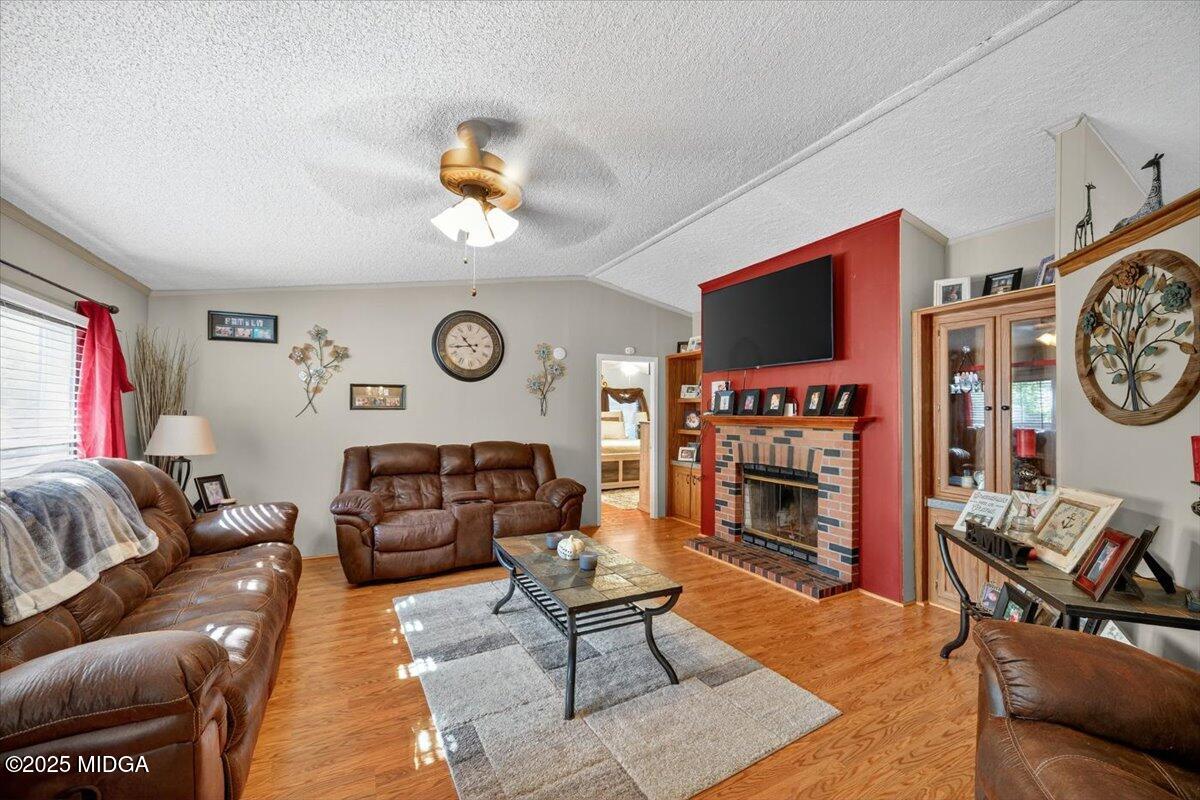 1659 Henderson Road Macon, GA 31217 - Photo 3 of 44 a living room with furniture a flat screen tv and a fireplace