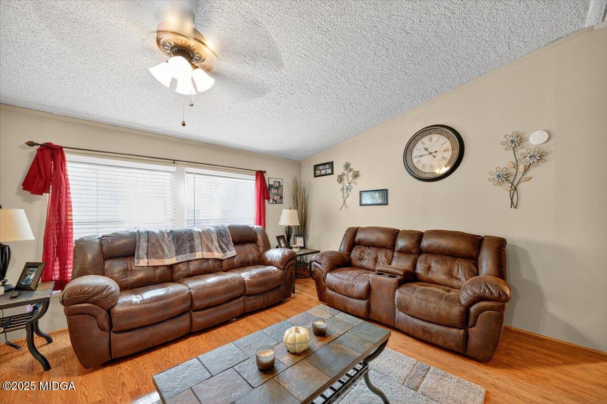 1659 Henderson Road Macon, GA 31217 - Photo 4 of 44 a living room with furniture a clock and a window