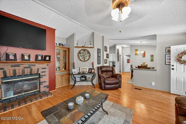 a living room with furniture a flat screen tv and a fireplace