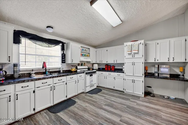 a kitchen with sink cabinets and window