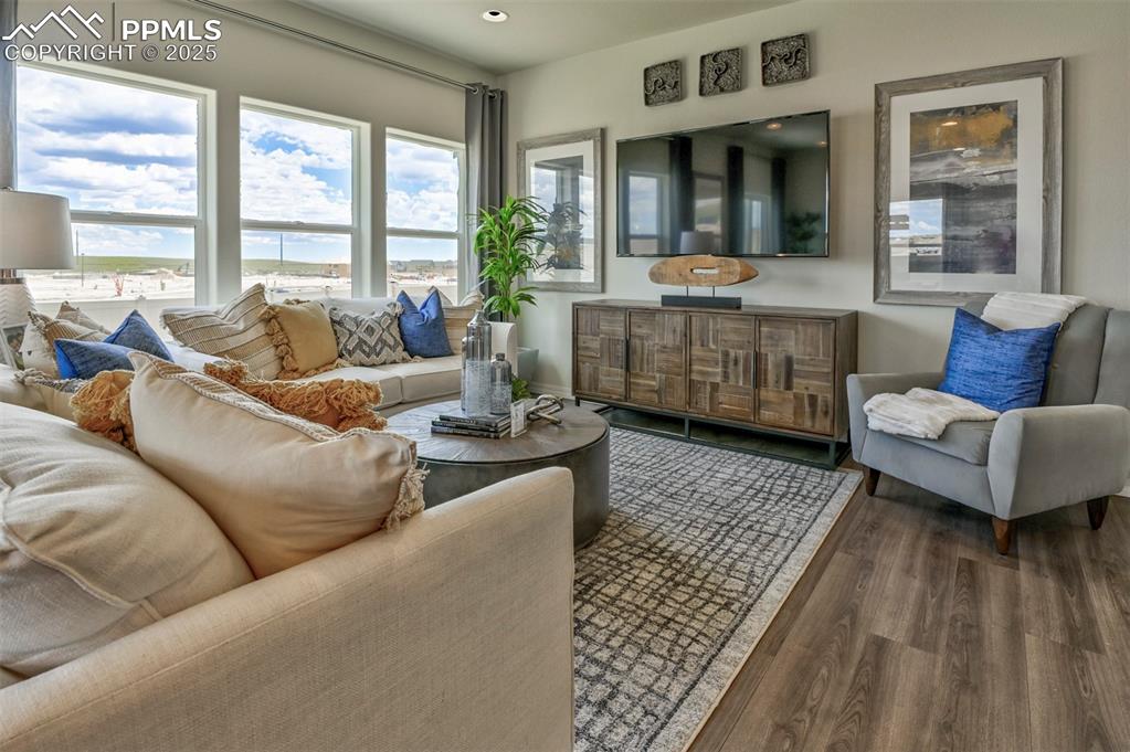 10847 Raylan Way Peyton, CO 80831 - Photo 17 of 40 a living room with furniture and large windows