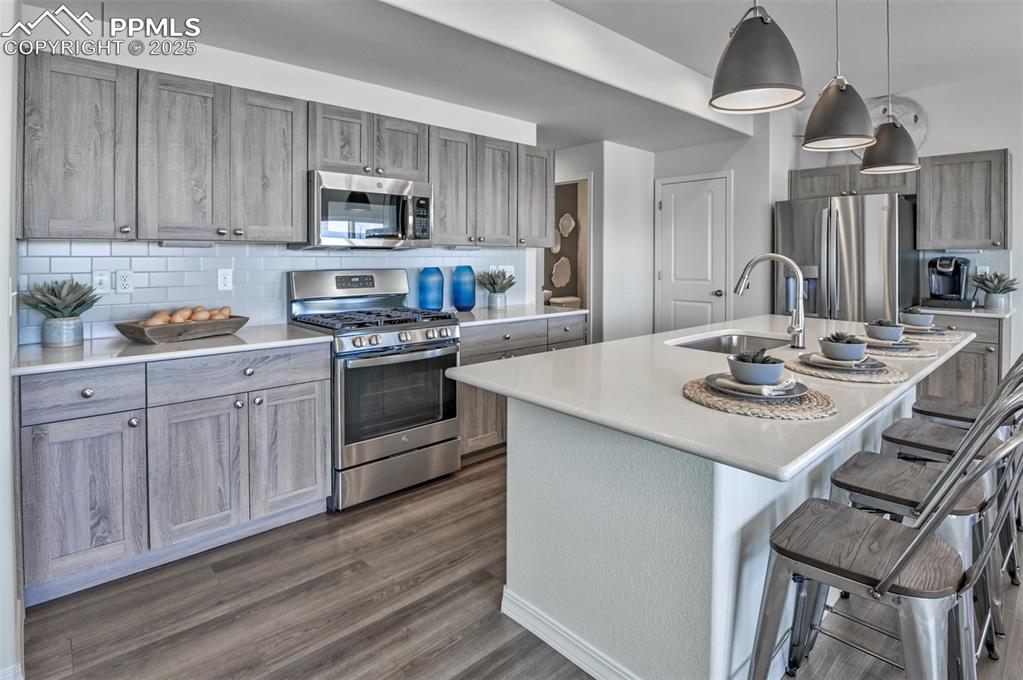 10847 Raylan Way Peyton, CO 80831 - Photo 21 of 40 a kitchen with granite countertop a sink stove and cabinets