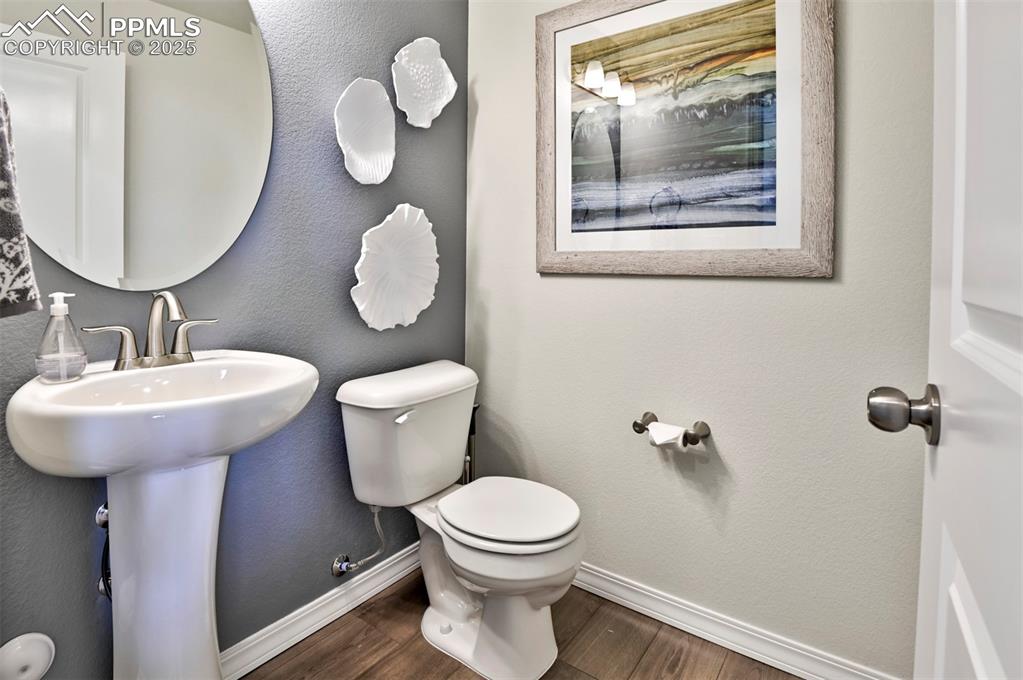 10847 Raylan Way Peyton, CO 80831 - Photo 24 of 40 a bathroom with a toilet a sink and mirror