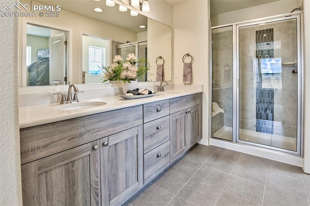 10847 Raylan Way Peyton, CO 80831 - Photo 30 of 40 a spacious bathroom with double sink and a mirror