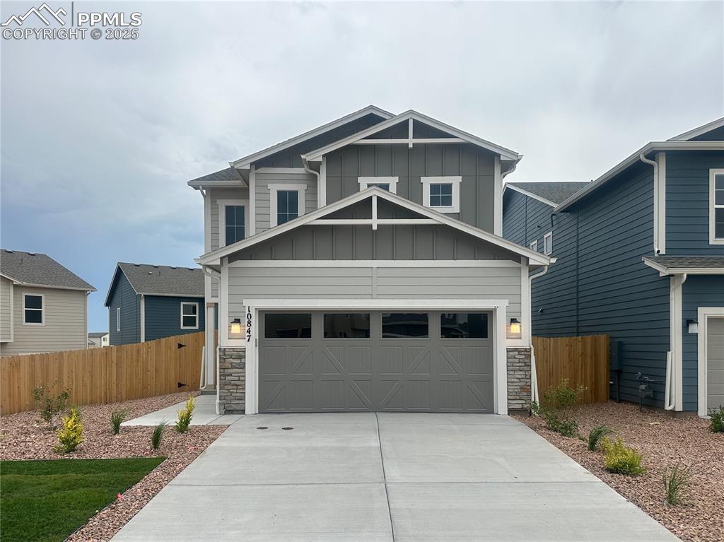 10847 Raylan Way Peyton, CO 80831 - Photo 3 of 40 a front view of a house with a yard and garage