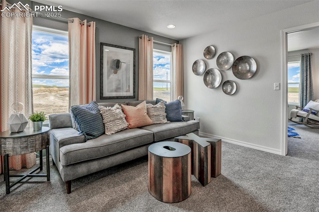 10847 Raylan Way Peyton, CO 80831 - Photo 35 of 40 a living room with furniture and a large window