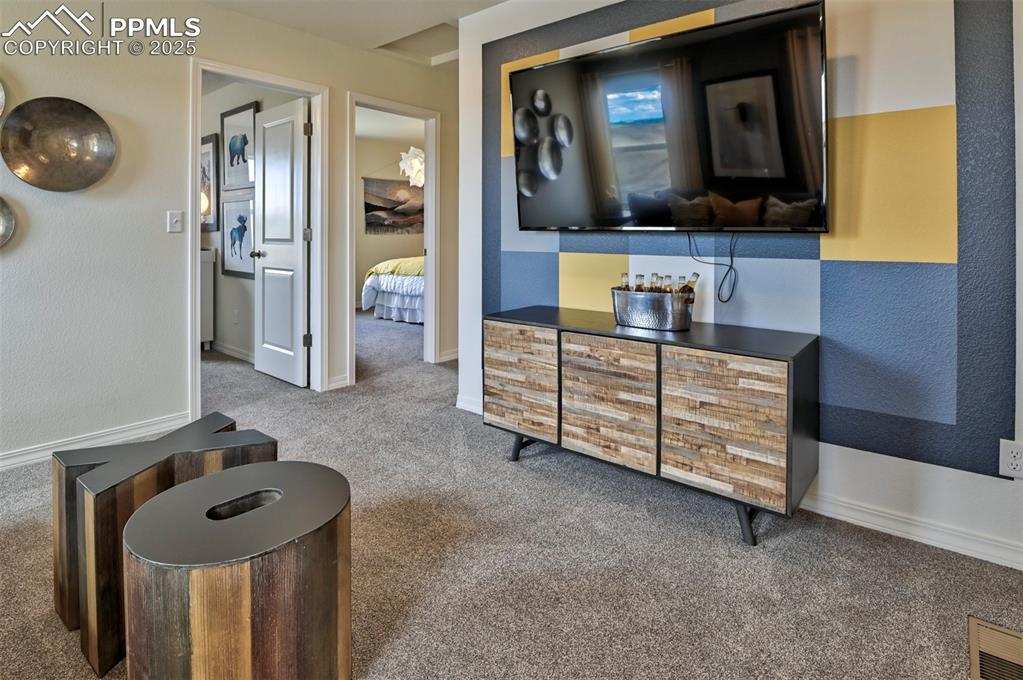 10847 Raylan Way Peyton, CO 80831 - Photo 36 of 40 a bathroom with a sink a light fixture and a mirror