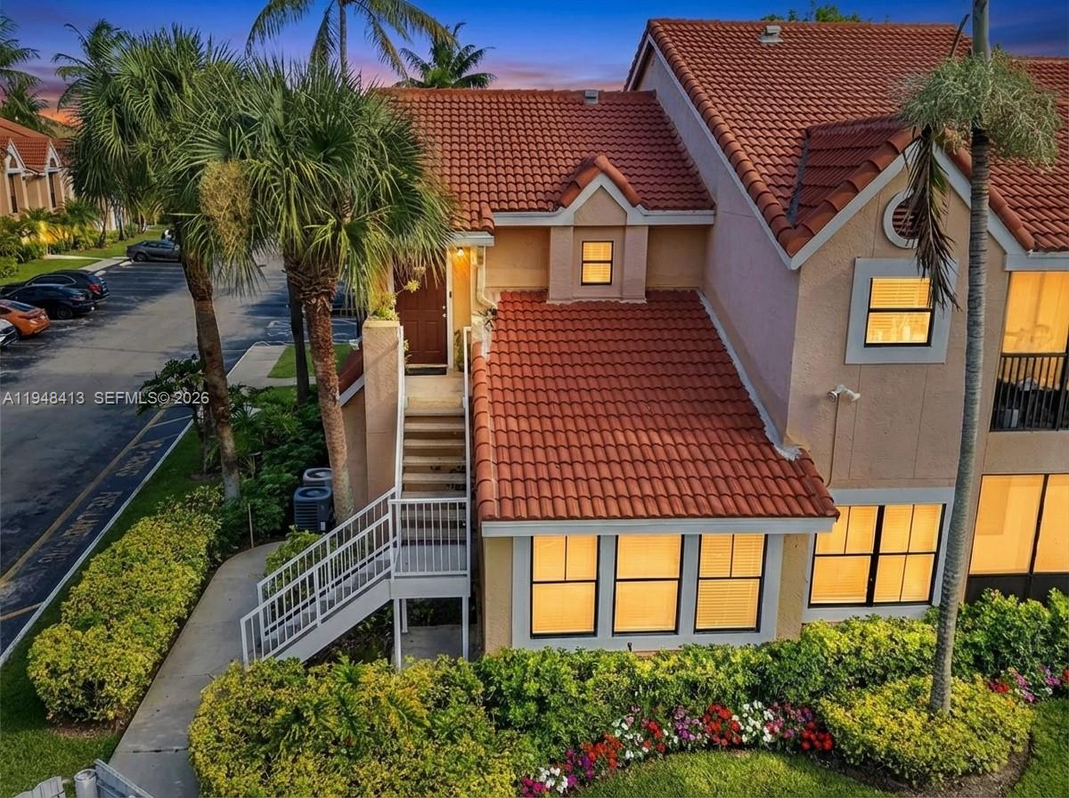 a front view of a house with a garden