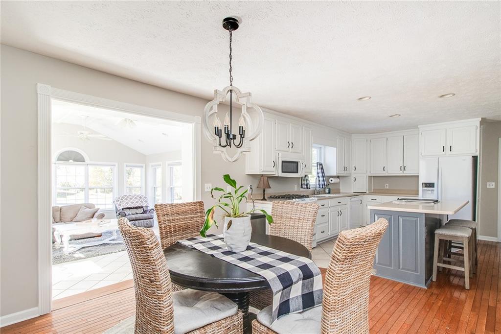3925 Mark Lake Road Cumming, GA 30028 - Photo 11 of 59 a view of a dining room and livingroom with furniture wooden floor a chandelier