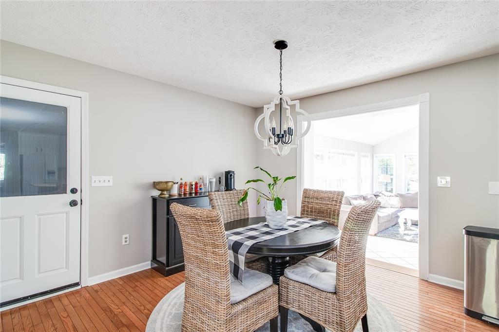3925 Mark Lake Road Cumming, GA 30028 - Photo 12 of 59 a view of a dining room with furniture wooden floor and chandelier