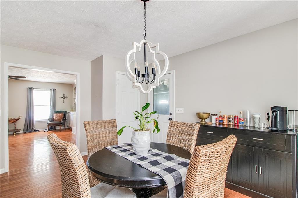 3925 Mark Lake Road Cumming, GA 30028 - Photo 13 of 59 a view of a dining room with furniture and wooden floor