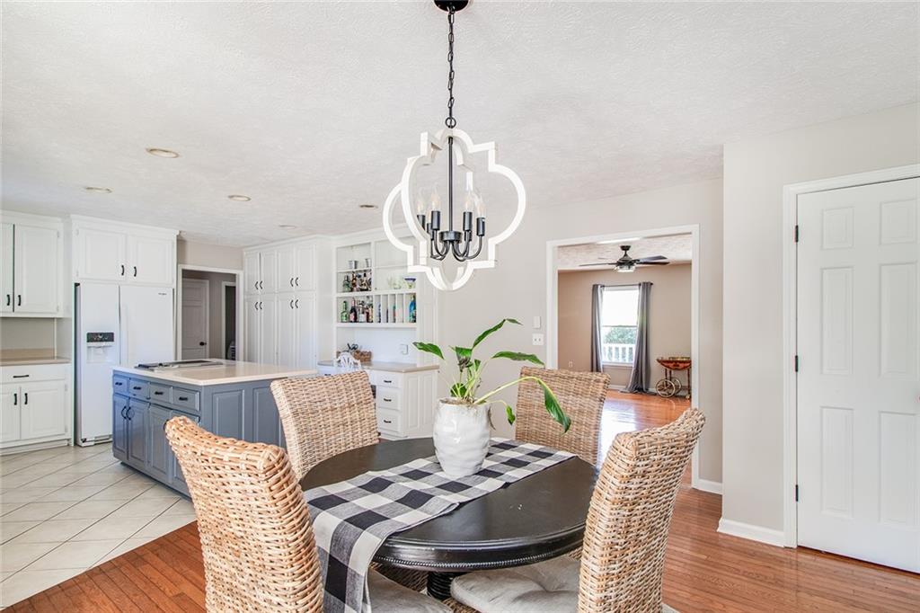 3925 Mark Lake Road Cumming, GA 30028 - Photo 14 of 59 a view of a dining room with furniture and wooden floor