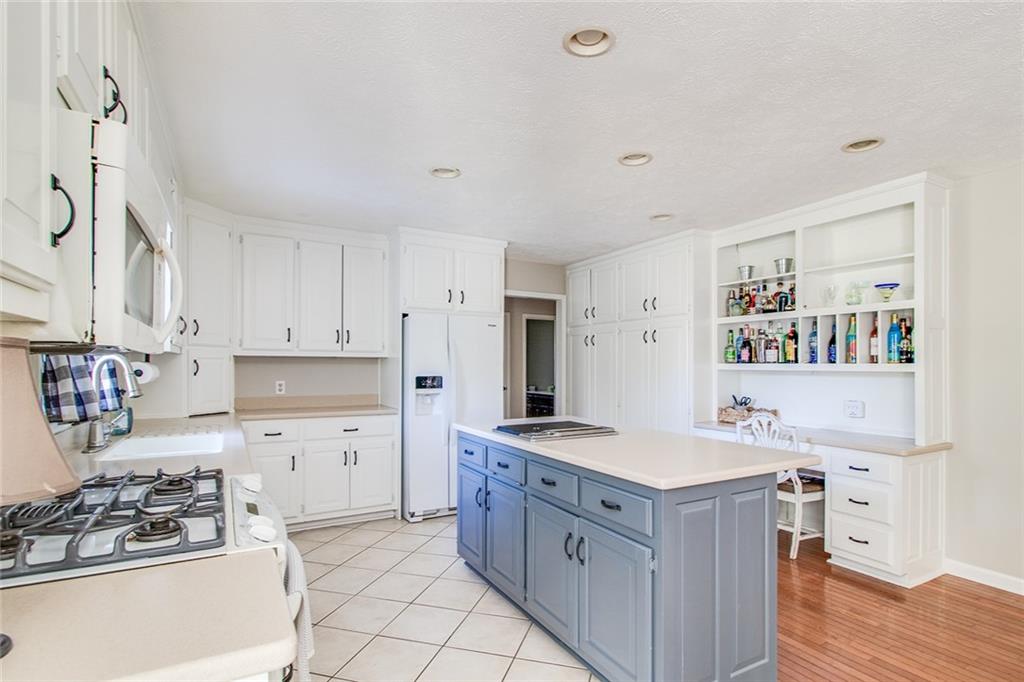3925 Mark Lake Road Cumming, GA 30028 - Photo 15 of 59 a kitchen with a stove a sink and a refrigerator