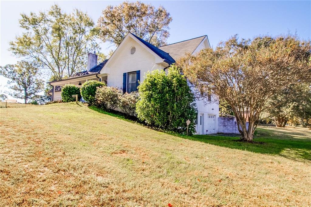 3925 Mark Lake Road Cumming, GA 30028 - Photo 2 of 59 a view of a house with yard and tree s