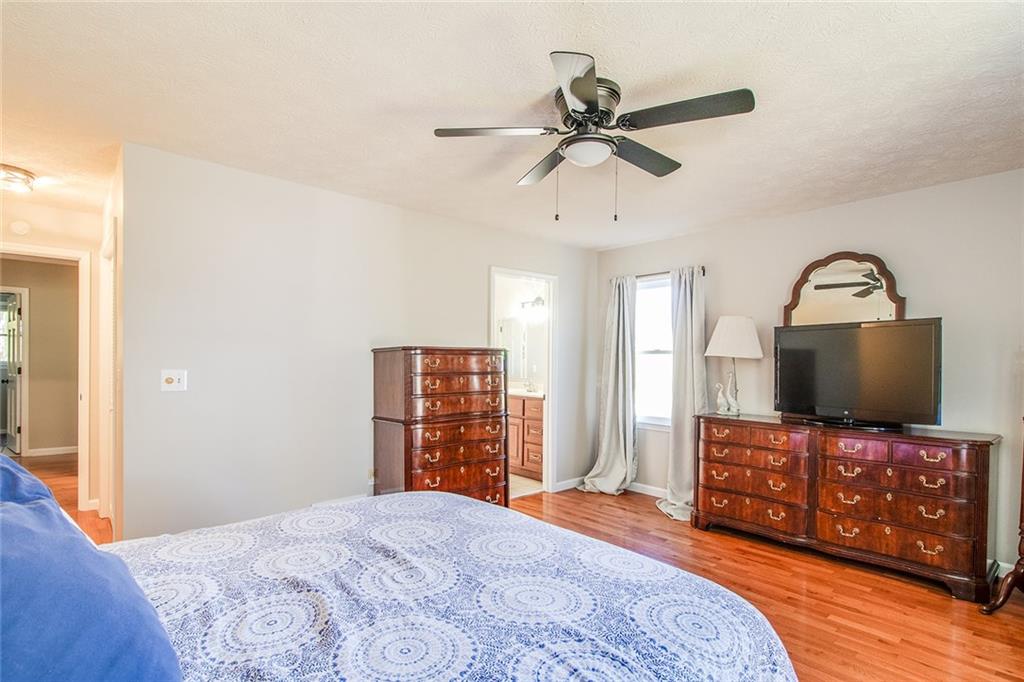 3925 Mark Lake Road Cumming, GA 30028 - Photo 22 of 59 a bedroom with a bed and a flat screen tv