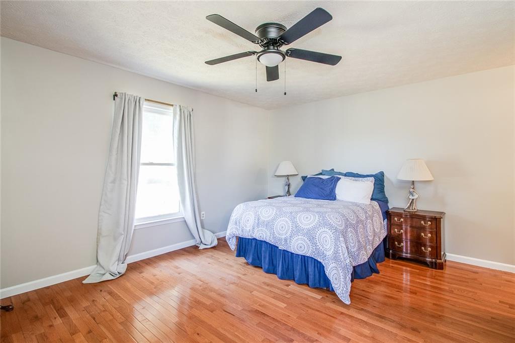 3925 Mark Lake Road Cumming, GA 30028 - Photo 23 of 59 a bedroom with a bed and a ceiling fan