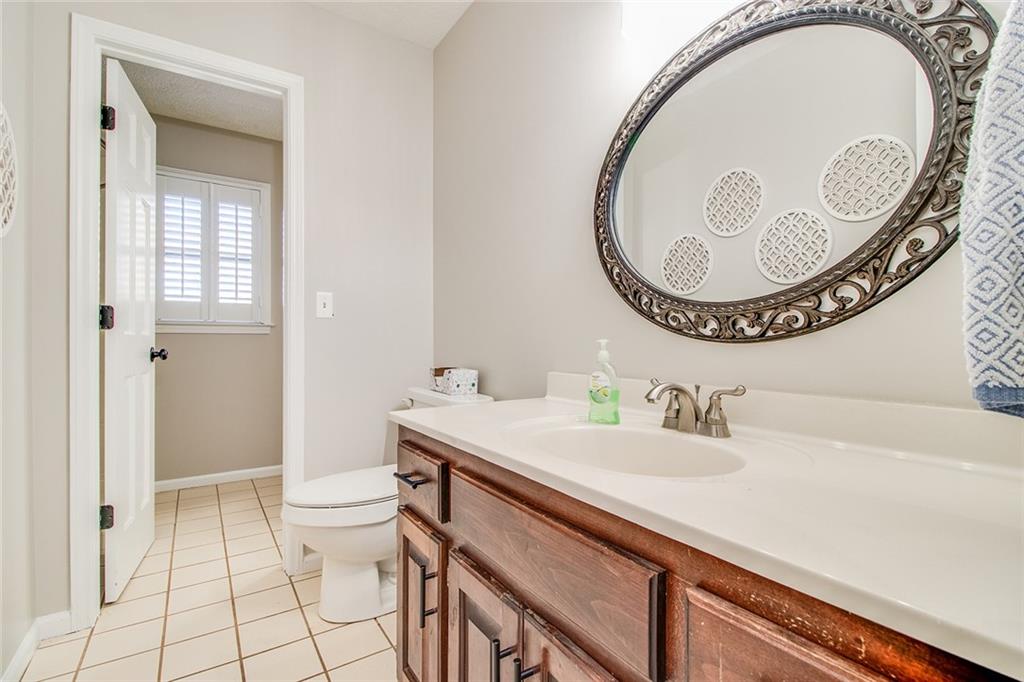 3925 Mark Lake Road Cumming, GA 30028 - Photo 25 of 59 a bathroom with a sink a toilet and a mirror