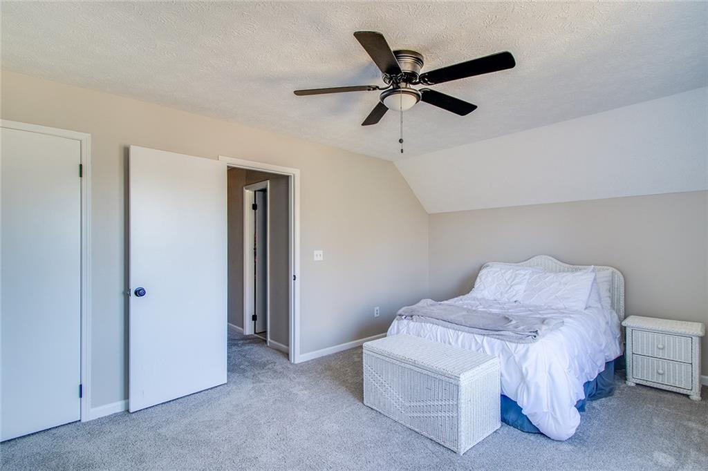 3925 Mark Lake Road Cumming, GA 30028 - Photo 30 of 59 a bedroom with a bed and a ceiling fan