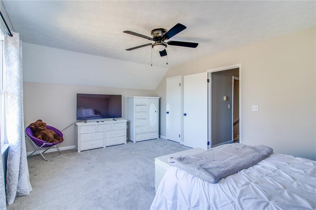 3925 Mark Lake Road Cumming, GA 30028 - Photo 31 of 59 a bedroom with a bed and a flat screen tv