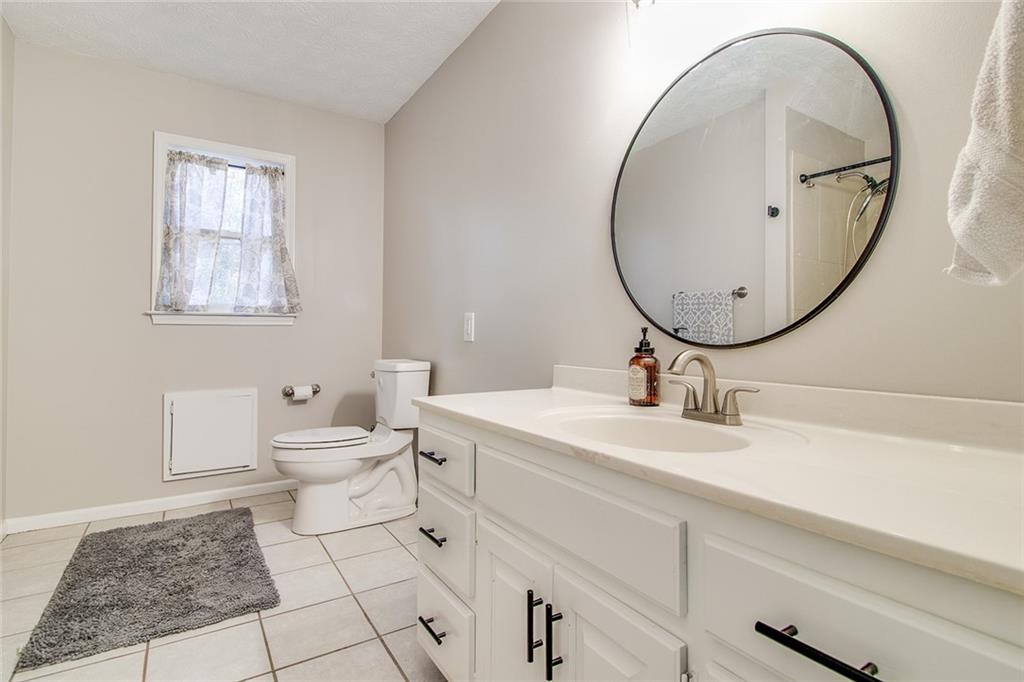 3925 Mark Lake Road Cumming, GA 30028 - Photo 32 of 59 a bathroom with a toilet sink and mirror