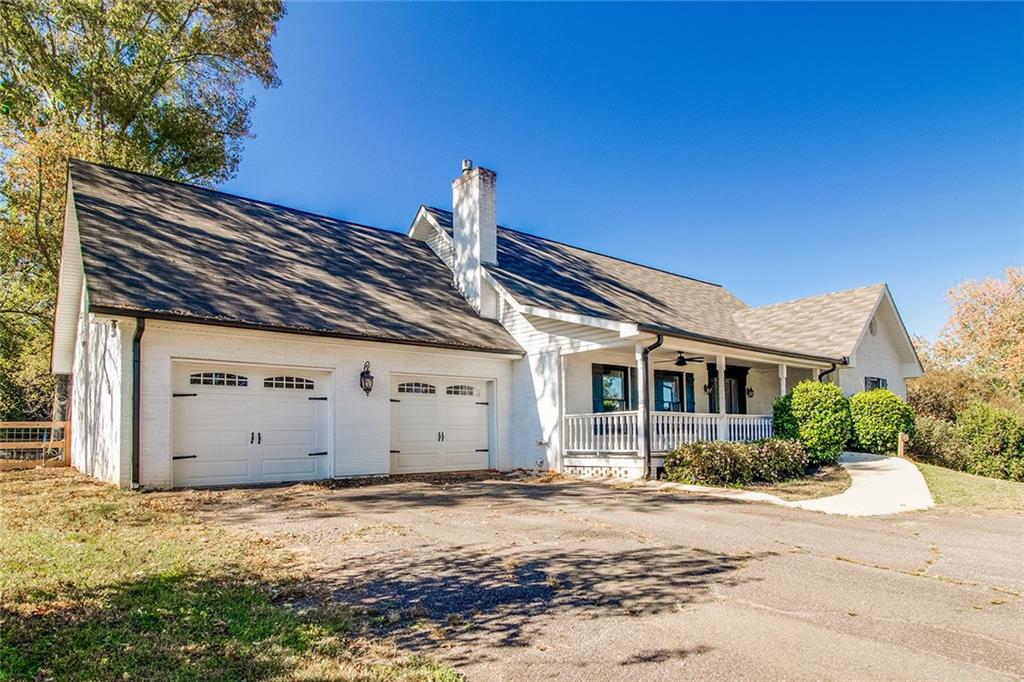 3925 Mark Lake Road Cumming, GA 30028 - Photo 4 of 59 a front view of a house with a yard