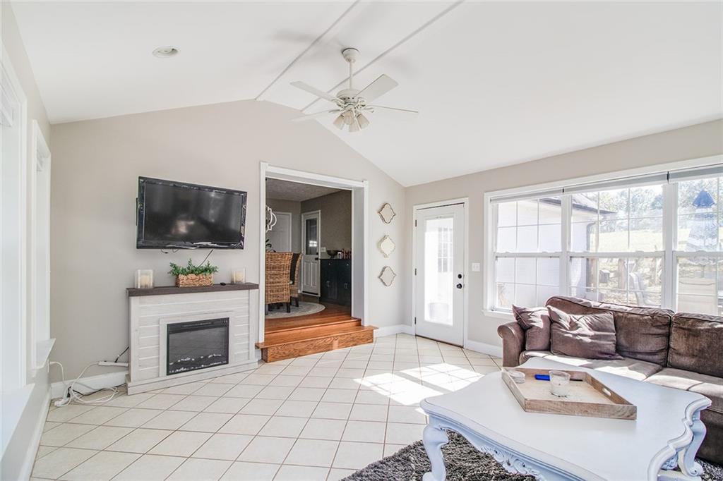 3925 Mark Lake Road Cumming, GA 30028 - Photo 47 of 59 a living room with furniture a flat screen tv and a fireplace