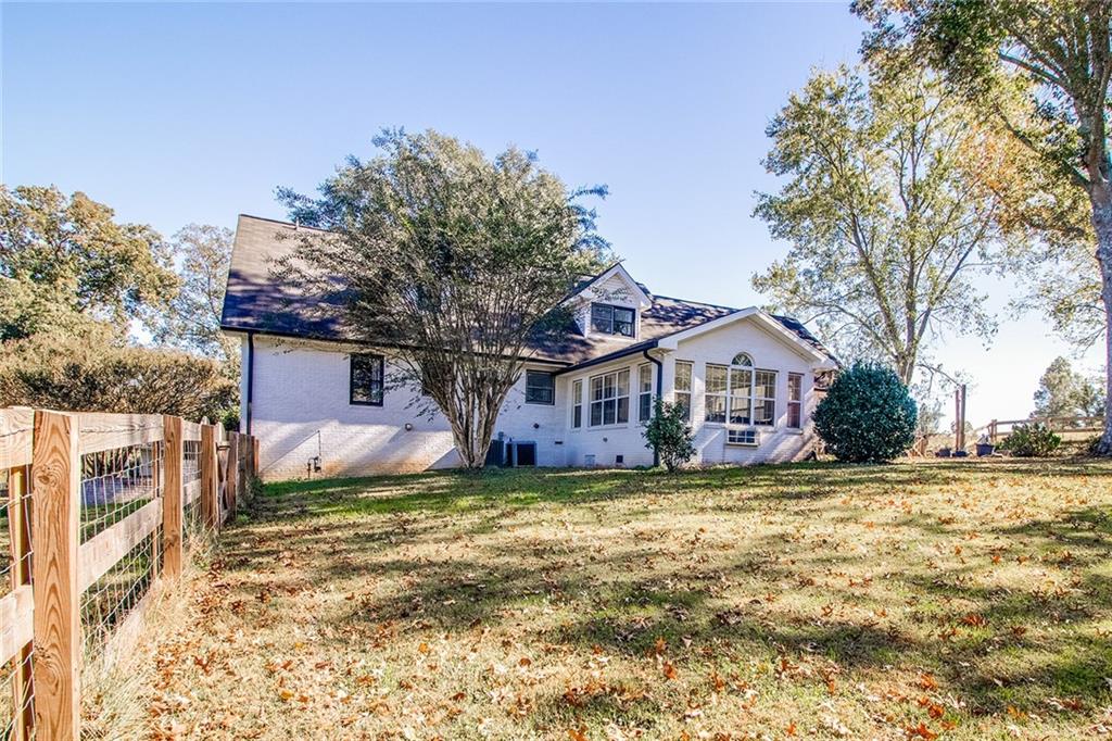 3925 Mark Lake Road Cumming, GA 30028 - Photo 55 of 59 a white house that has a tree in front of it