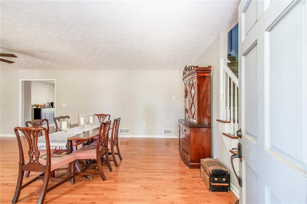 3925 Mark Lake Road Cumming, GA 30028 - Photo 8 of 59 a view of a dining room with furniture and wooden floor