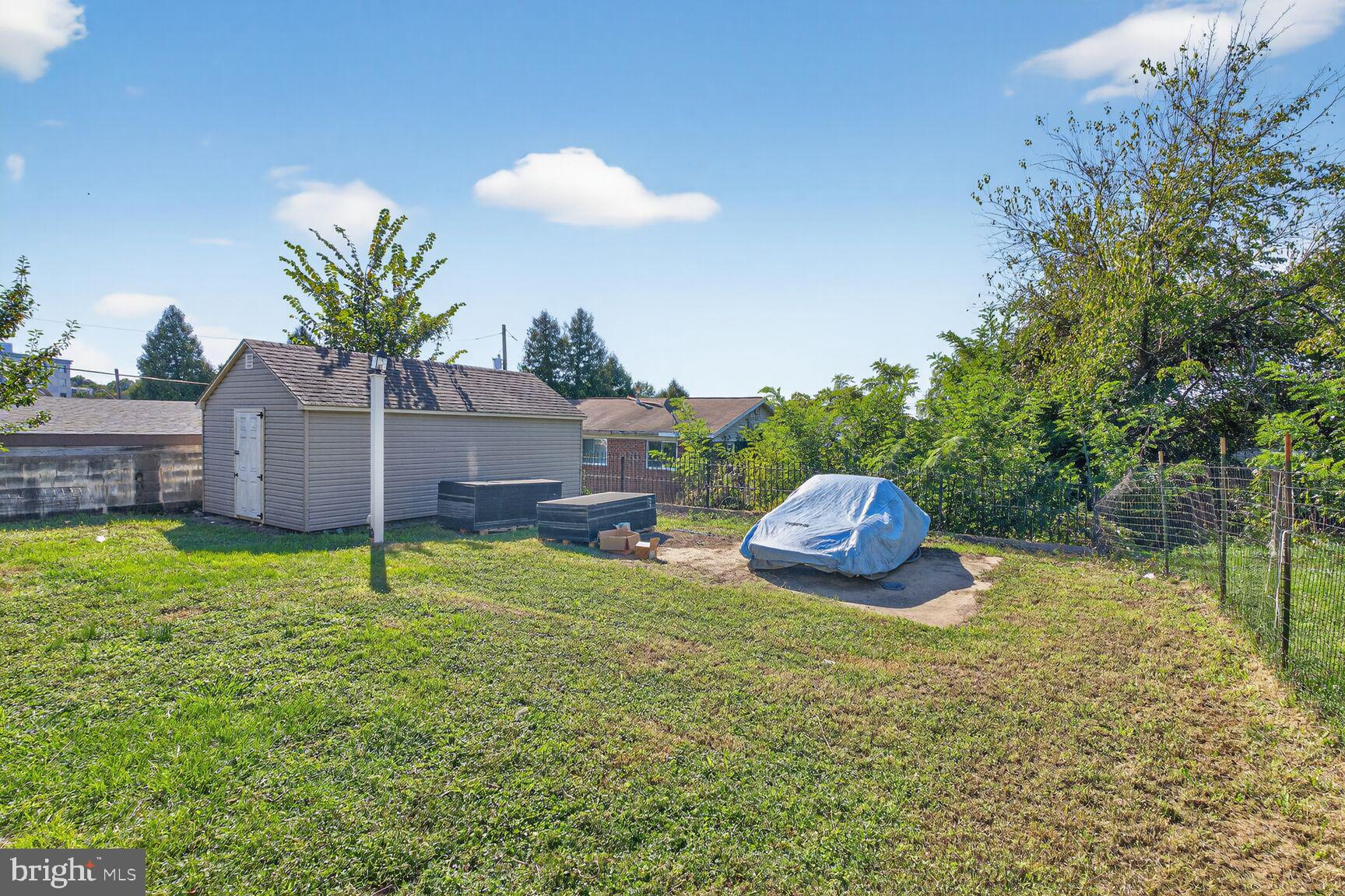 260 45th Street Northeast Washington, DC 20019 - Photo 18 of 19 Spacious yard with shed and greenery.