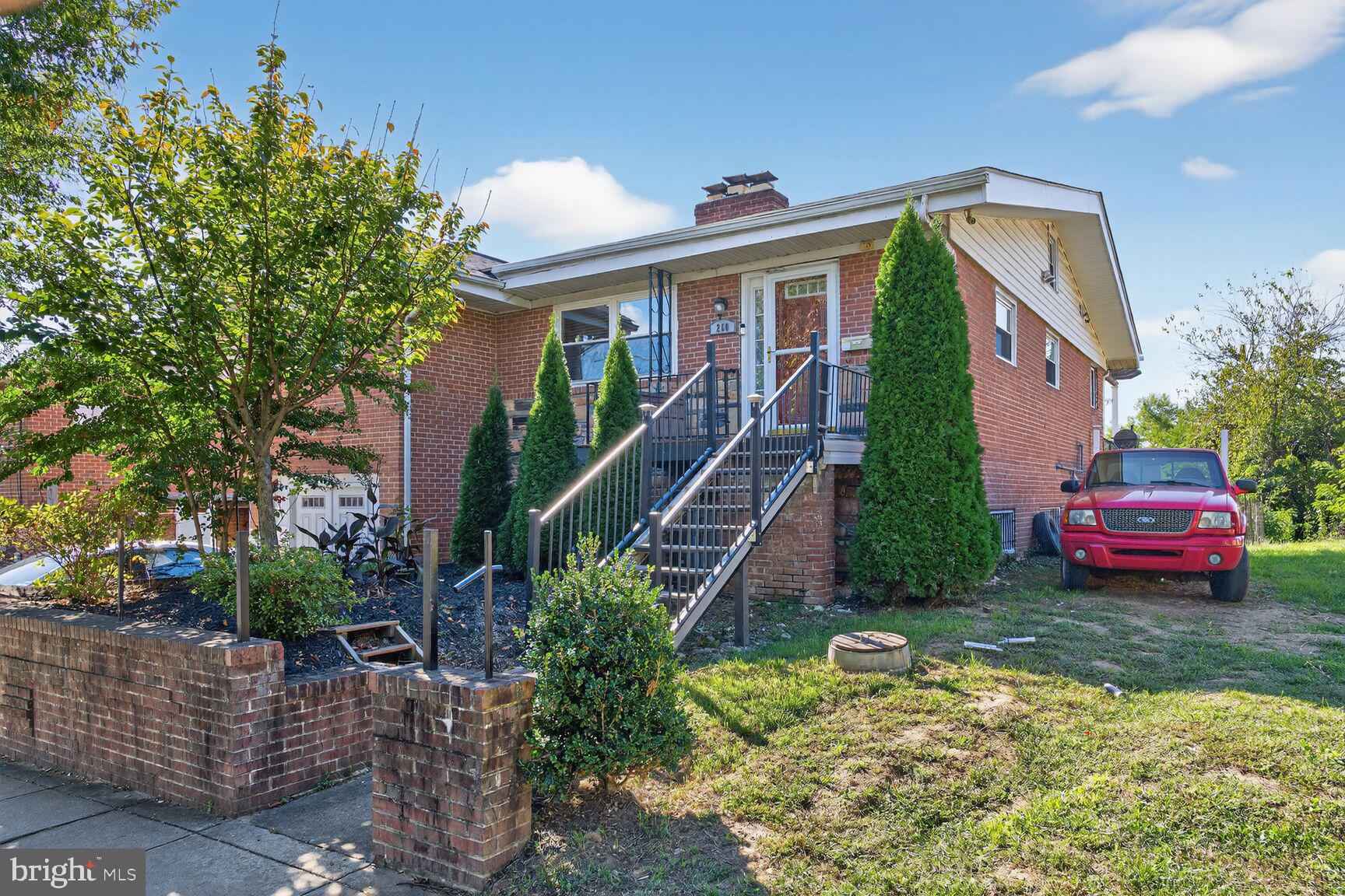 260 45th Street Northeast Washington, DC 20019 - Photo 2 of 19 Charming brick home with lush greenery.