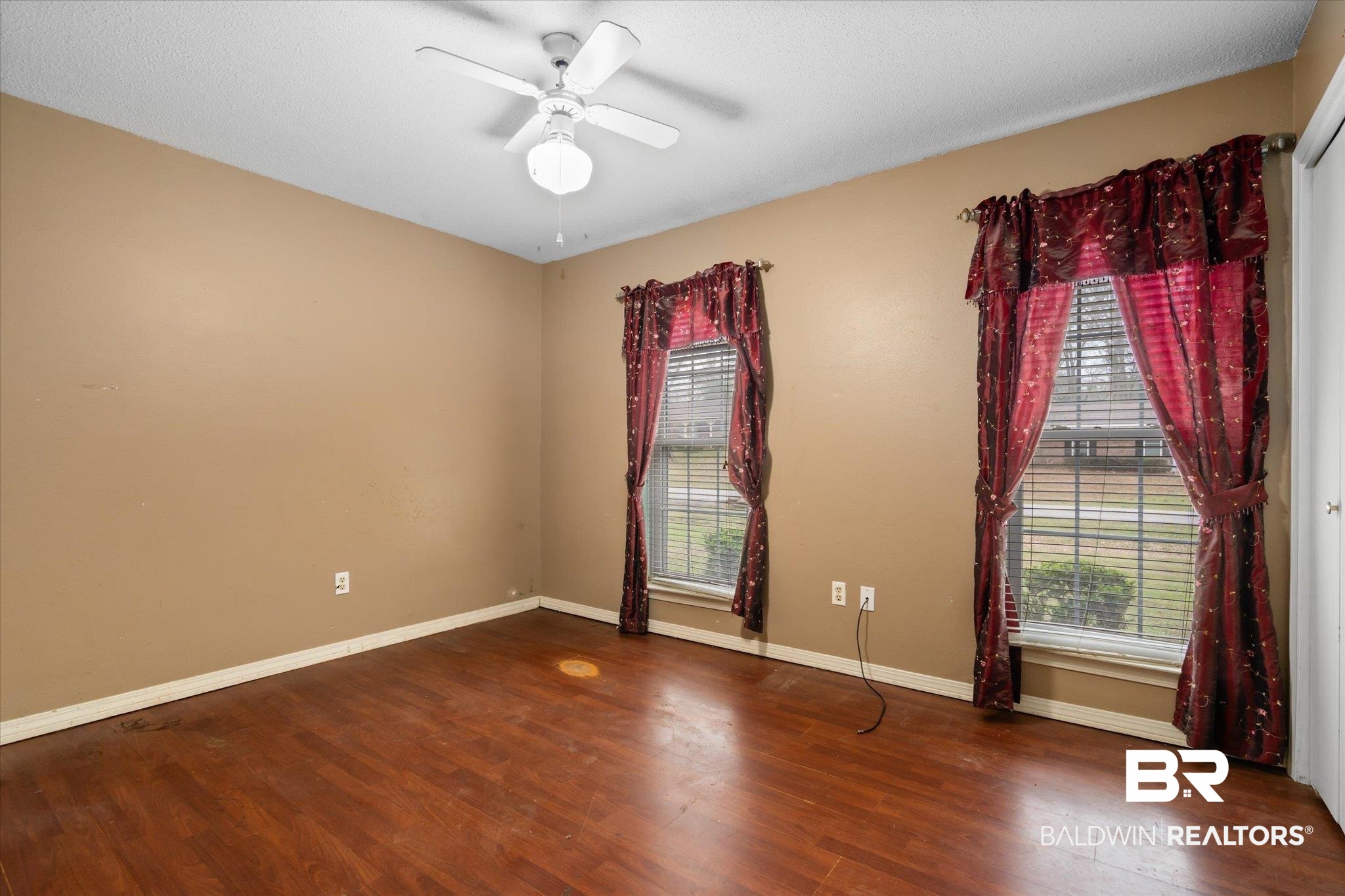 3541 Winston Drive Semmes, AL 36575 - Photo 14 of 20 Spare room with dark wood finished floors, a ceiling fan, and baseboards