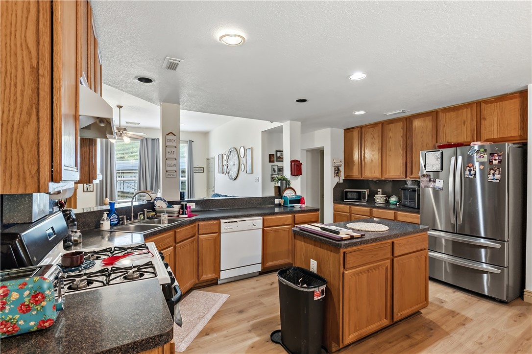 11901 Bundic Road North Zulch, TX 77872 - Photo 12 of 29 a kitchen with stainless steel appliances granite countertop a sink stove and refrigerator