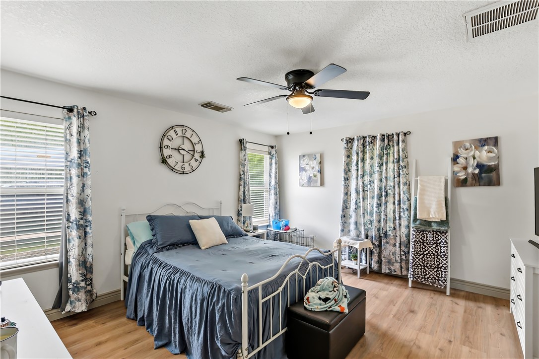 11901 Bundic Road North Zulch, TX 77872 - Photo 15 of 29 a bedroom with a bed and a chandelier