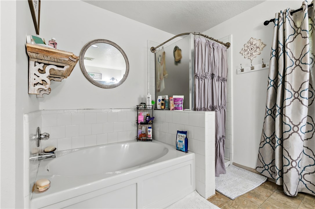 11901 Bundic Road North Zulch, TX 77872 - Photo 18 of 29 a bathroom with a bathtub and a shower