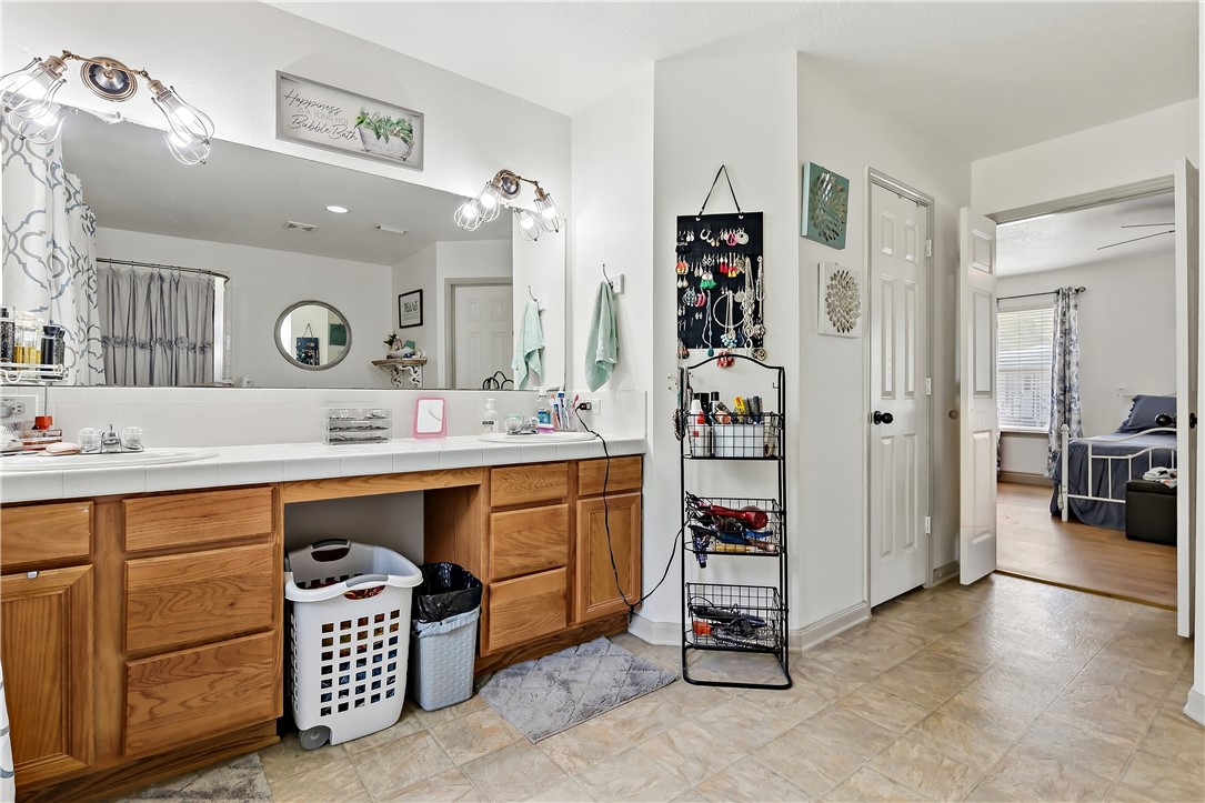 11901 Bundic Road North Zulch, TX 77872 - Photo 19 of 29 a spacious bathroom with a double vanity sink shower and a mirror