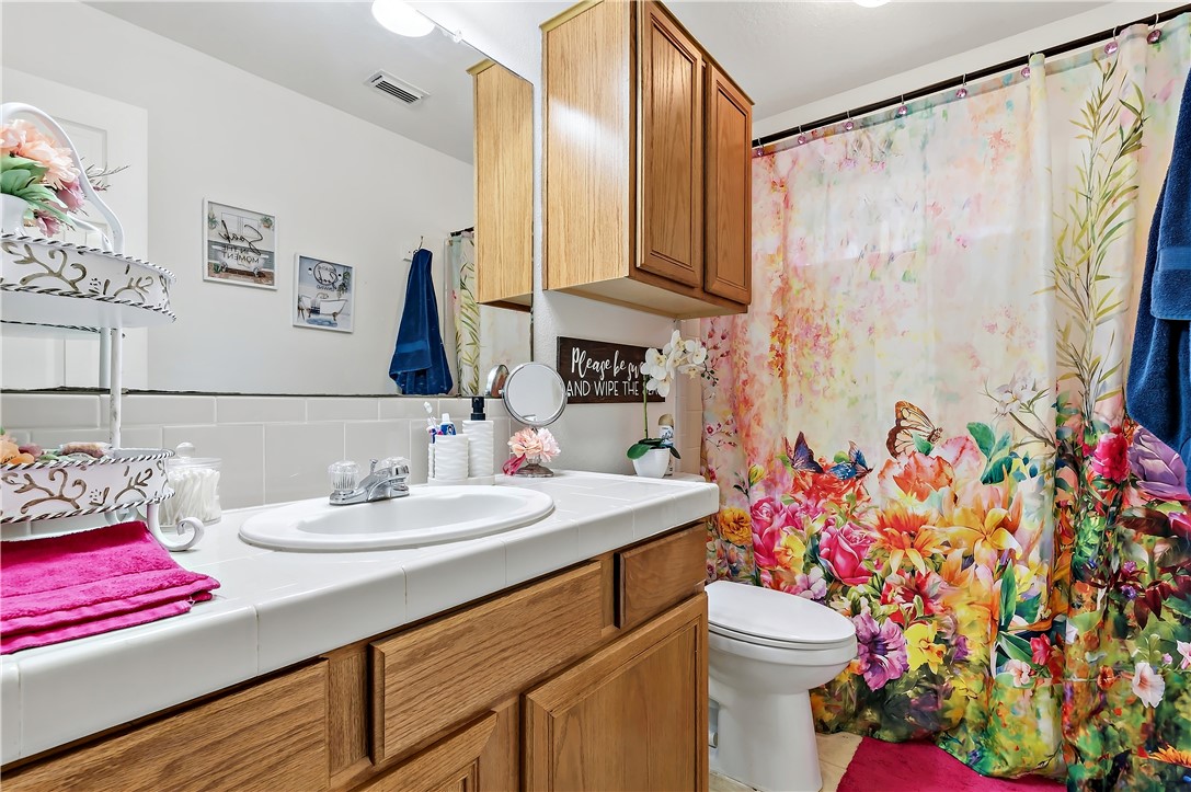 11901 Bundic Road North Zulch, TX 77872 - Photo 22 of 29 a bathroom with a sink vanity mirror and vanity