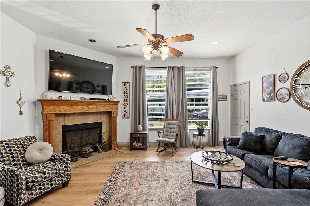 11901 Bundic Road North Zulch, TX 77872 - Photo 6 of 29 a living room with furniture a flat screen tv and a fireplace