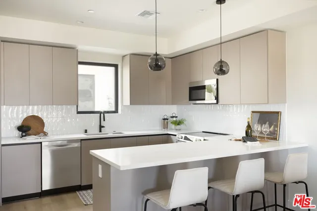 a kitchen with a sink a counter space and a window